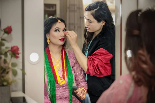 Traditional bridal makeup with gold jewelry